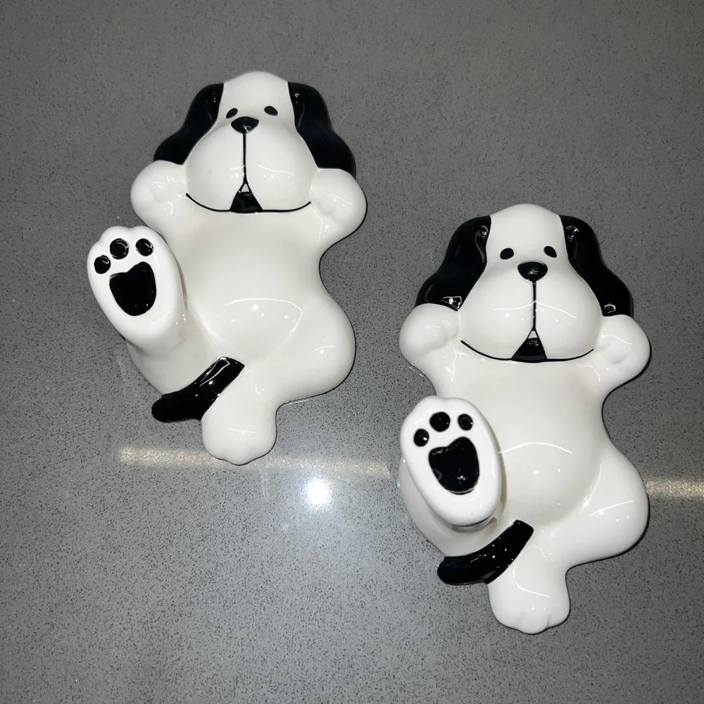 Two black-and-white dog wall hooks